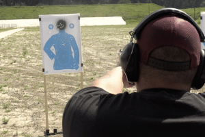 Man shooting a gun at a range